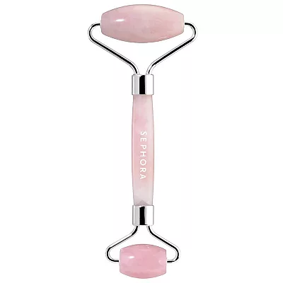 A dual-ended facial roller with a rose quartz stone and metallic handle inscribed with 'SEPHORA'. It is designed for facial massage and skincare enhancement.