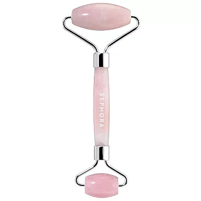 A dual-ended facial roller with a rose quartz stone and metallic handle inscribed with 'SEPHORA'. It is designed for facial massage and skincare enhancement.
