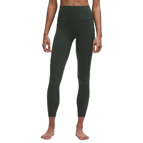 Dark green high-waisted leggings worn by a model, showcasing a form-fitting design.