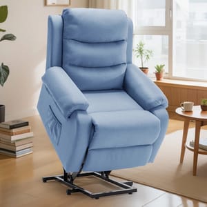 A light blue lift chair recliner with padded armrests and a side pocket is shown in a cozy living room setting with wooden floors and plants.