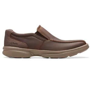 Brown leather slip-on shoe with a thick rubber sole, designed for casual wear. Features visible stitching and a low-profile design.