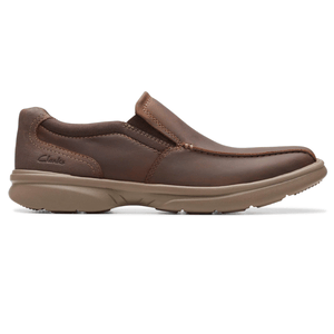 Brown leather slip-on shoe with a thick rubber sole, designed for casual wear. Features visible stitching and a low-profile design.