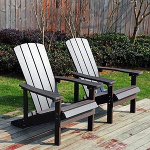 Two Adirondack chairs with connecting table are displayed, made from dark and light gray slats, on an outdoor deck.