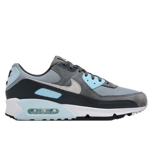 Nike Men's Air Max 90 Sneakers feature a mix of grey, light blue, and white tones with a visible air cushioning unit in the heel, a mesh and leather upper for breathability, and a durable rubber outsole for traction.