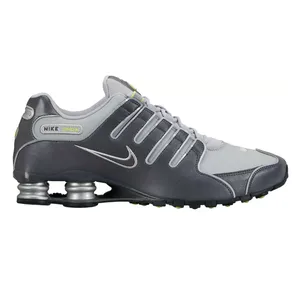 Nike Shox sneakers in gray and silver with a signature Swoosh and spring-based cushioning system for added comfort and support.
