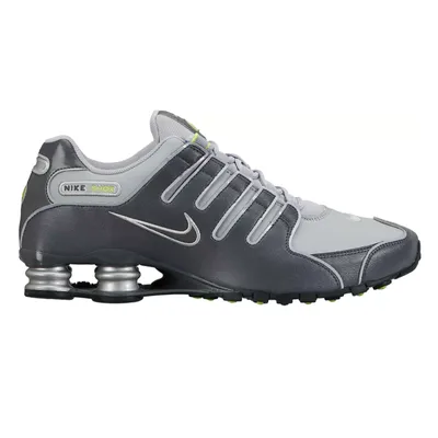 Nike Shox sneakers in gray and silver with a signature Swoosh and spring-based cushioning system for added comfort and support.