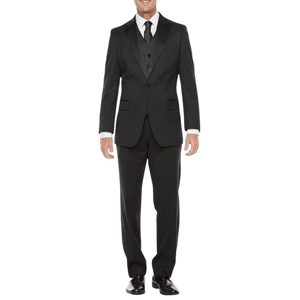 A man is wearing a black three-piece suit consisting of a jacket, vest, and trousers, paired with a white dress shirt and black tie. He completes the outfit with black dress shoes.