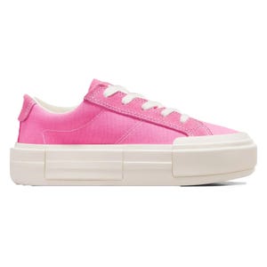 A pink canvas sneaker with white laces and a thick white sole.