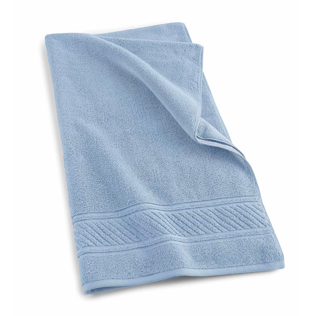 A light blue bath towel featuring a textured border design, made from soft, absorbent fabric.