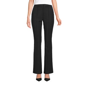 Black high-waisted flare pants paired with a white top and black pointed-toe heels.