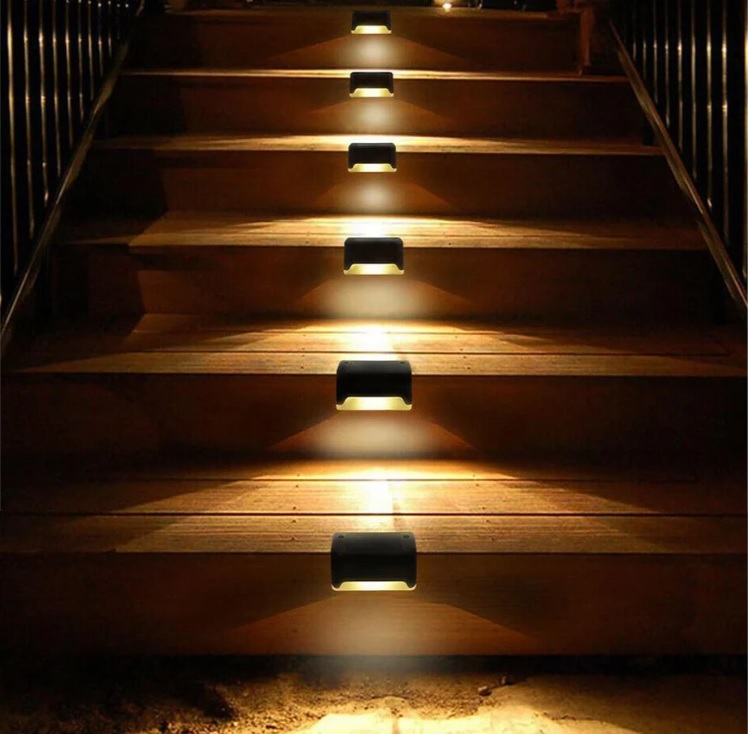 Staircase with installed LED stair lights providing illumination on each step.