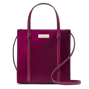 A fuchsia Kate Spade tote bag with a shoulder strap and a gold-tone logo plaque.