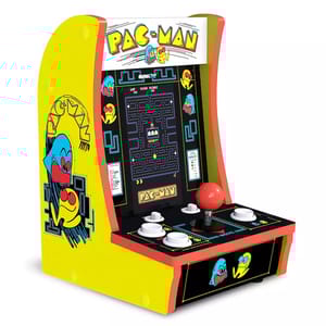 A miniature Pac-Man arcade game features a retro design with bright yellow sides, colorful graphics of Pac-Man and ghosts, and includes a joystick and buttons for gameplay, mimicking classic arcade machines.