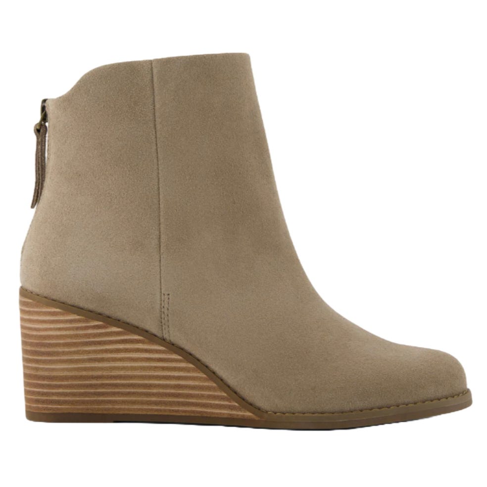 Beige suede ankle boot with a stacked wedge heel and a back zipper.