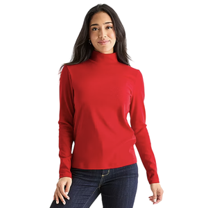 A woman is wearing a long-sleeve red turtleneck shirt paired with dark blue jeans.