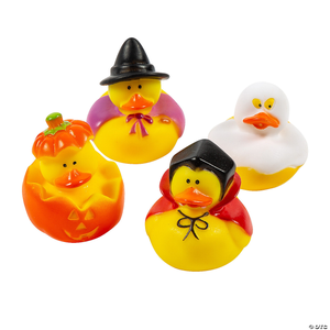 Four rubber ducks in Halloween costumes: a witch, a ghost, a pumpkin, and a vampire.