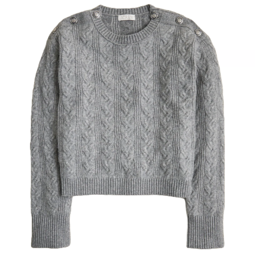 Gray cable knit sweater with button details on the shoulders, featuring ribbed cuffs and hem.