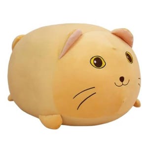 A round, plush toy resembling a cute, smiling cat with a beige color and simple facial features.