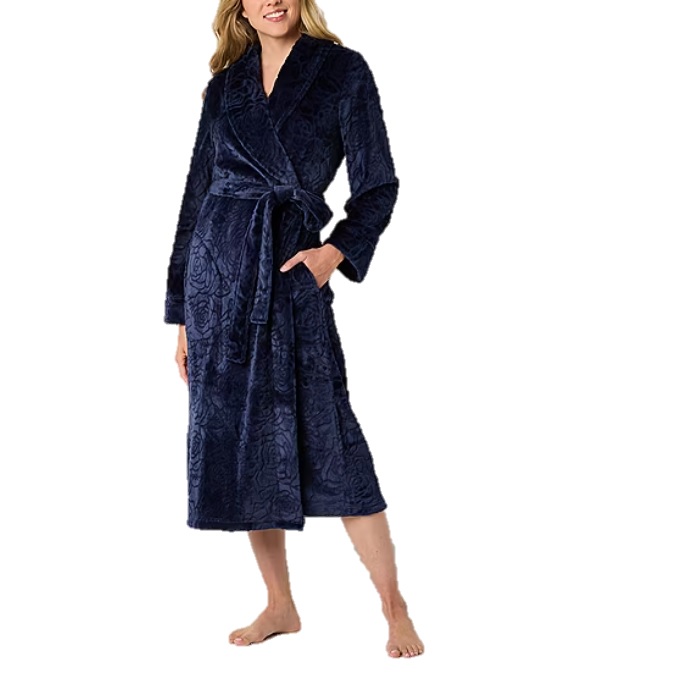 A woman is wearing a long, dark blue bathrobe with a textured floral pattern, complete with a waist tie and long sleeves.