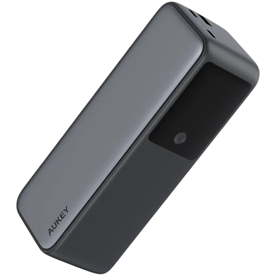 A sleek, rectangular AUKEY power bank with a smooth gray finish and a black section featuring an indicator light on one side.