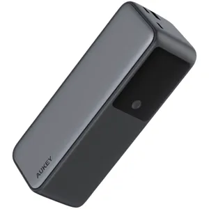 A sleek, rectangular AUKEY power bank with a smooth gray finish and a black section featuring an indicator light on one side.