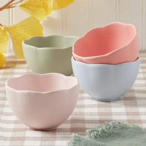 Set of four stoneware tidbit bowls in pastel colors: soft pink, green, blue, and coral, featuring a scalloped edge design.
