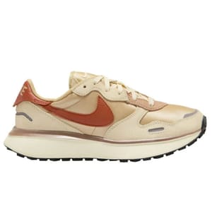 A beige and rust-colored Nike sneaker featuring a prominent Swoosh logo, designed for casual wear with a thick sole and low-top silhouette.
