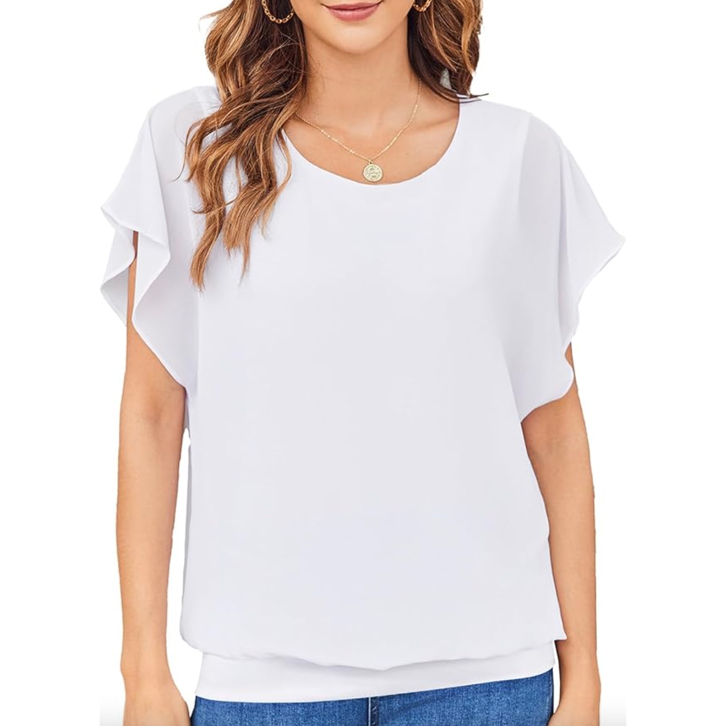 White short-sleeve blouse with flutter sleeves and a round neckline, paired with blue jeans, accessorized with a necklace and hoop earrings.