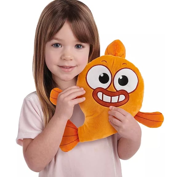 A 12-inch orange plush toy resembling a fish with large, expressive eyes and a big smile, held by a child in a light-colored shirt.