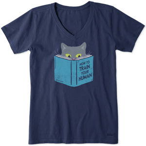 Navy blue V-neck t-shirt featuring a graphic of a cat peeking over a book titled \“How to Train Your Human.\“