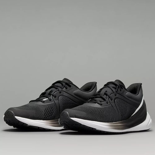 A pair of black running shoes with white soles.