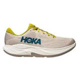 A beige and yellow HOKA running shoe with a blue logo, featuring a cushioned white sole and breathable mesh upper design.