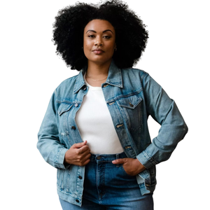 A person wears a blue denim jacket over a white top and high-waisted blue jeans.