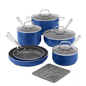 This 11-piece cookware set includes nonstick blue pots and pans with glass lids, metal handles, and two frying pans of varying sizes. It also features a gray trivet with utensil designs and is suitable for various cooking needs.