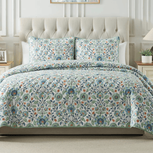 A 3-piece King Floral Quilt Set includes a quilt and two pillow shams, featuring a colorful floral pattern with blue, green, and orange hues on a light backdrop, providing a cozy and elegant look for a bedroom.