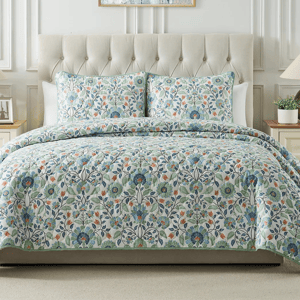 A 3-piece King Floral Quilt Set includes a quilt and two pillow shams, featuring a colorful floral pattern with blue, green, and orange hues on a light backdrop, providing a cozy and elegant look for a bedroom.