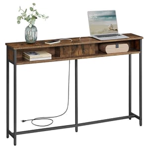 A slim console table with a rustic wood finish and black metal frame, featuring three compartments. It's decorated with a plant, a book, and a speaker, and holds a laptop.