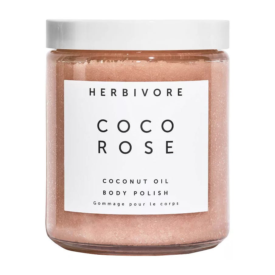Herbivore Botanicals Coco Rose Coconut Oil Body Polish is a pink body scrub designed to exfoliate and moisturize the skin. It features coconut oil for hydration and has a rose scent.