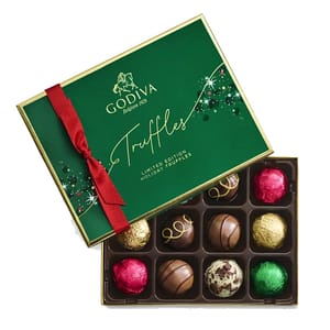 The 12-piece Godiva Holiday Truffle Gift Box features assorted chocolate truffles in vibrant red, gold, and green foil wrapping in a festive green box with a red ribbon. It is labeled as limited edition holiday truffles.