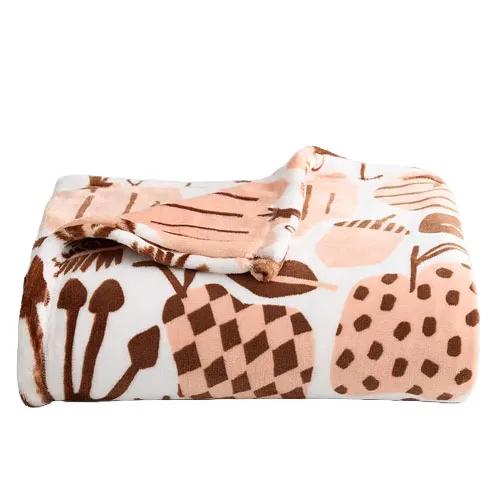A folded fleece blanket with a pattern of abstract shapes in light pink and brown on a white background.