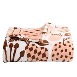 A folded fleece blanket with a pattern of abstract shapes in light pink and brown on a white background.