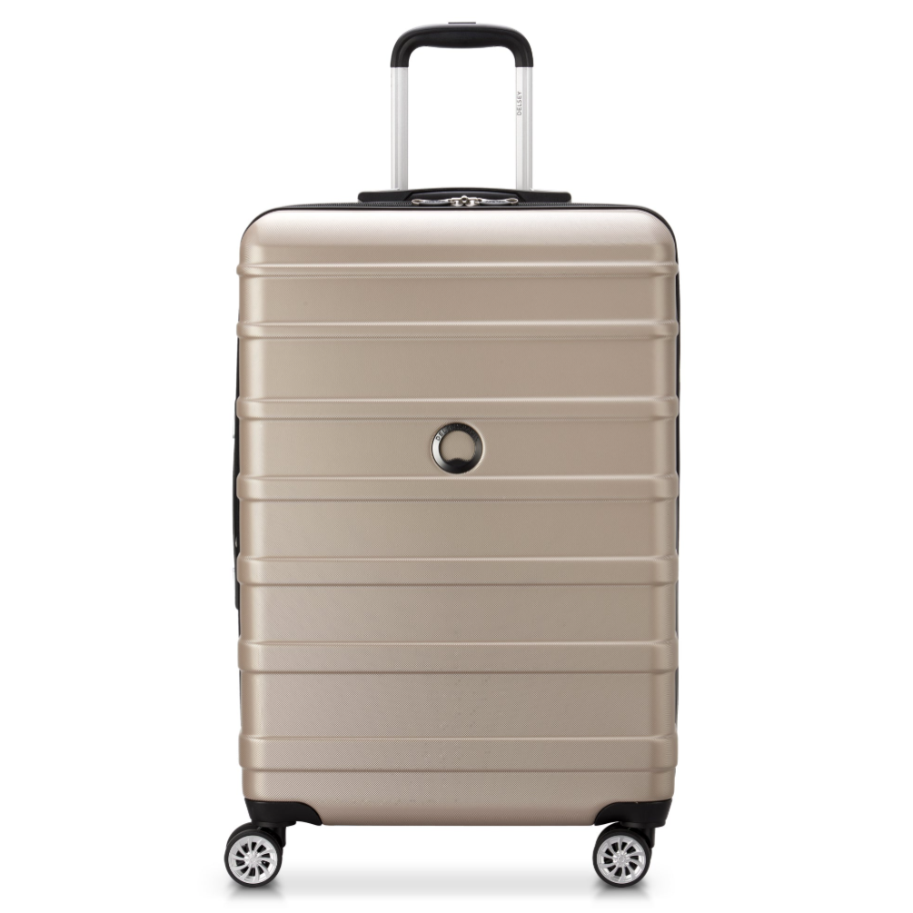 A beige hard-shell suitcase with four spinner wheels and a telescopic handle.