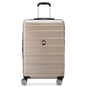 A beige hard-shell suitcase with four spinner wheels and a telescopic handle.