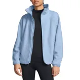 A person wearing a light blue fleece jacket over a black top and black leggings.