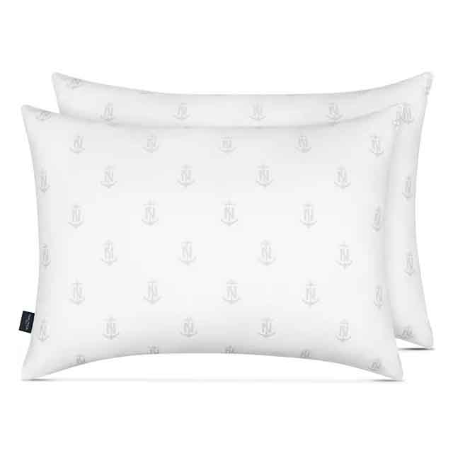 Two white, rectangular Nautica pillows with a subtle anchor and \“N\“ pattern, designed for all sleep positions.