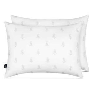 Two white, rectangular Nautica pillows with a subtle anchor and \“N\“ pattern, designed for all sleep positions.