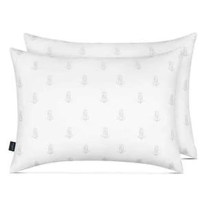 Two white, rectangular Nautica pillows with a subtle anchor and \“N\“ pattern, designed for all sleep positions.