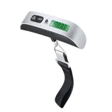 A digital luggage scale with a black strap and metal hook, featuring a display for weight measurements in pounds and kilograms alongside buttons for power, unit selection, and tare functions.