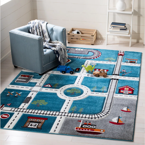 Children’s playroom with a blue chair and a colorful play rug featuring roads, train tracks, and a harbor scene. Toys include a blue truck, a dinosaur, and a wooden toy vehicle.