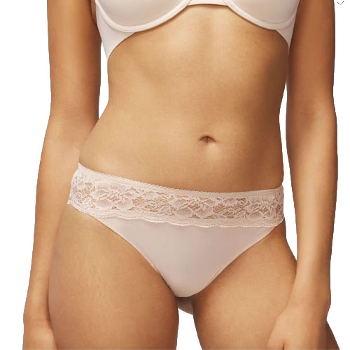 A model is wearing a light pink bra and matching panties featuring a lace waistband.
